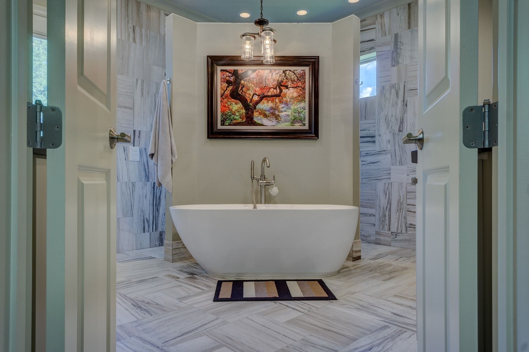 Luxury bathroom remodel with freestanding tub and marble tile